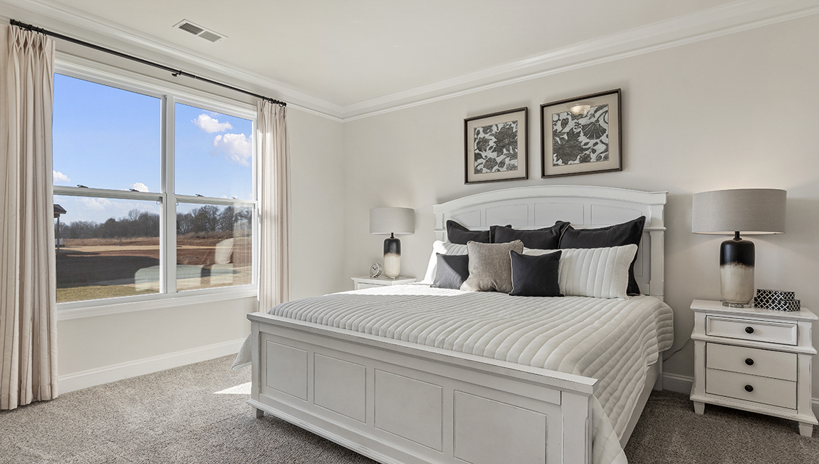 Bedroom with carpet and window.