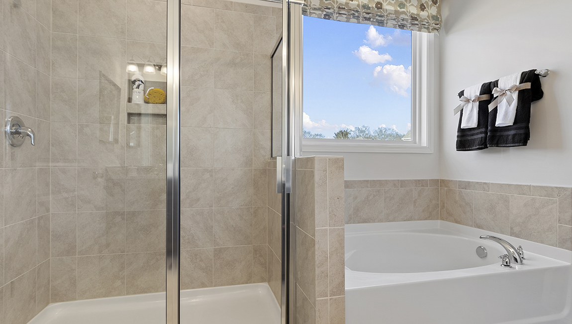 Bathroom with tub and walk in shower.