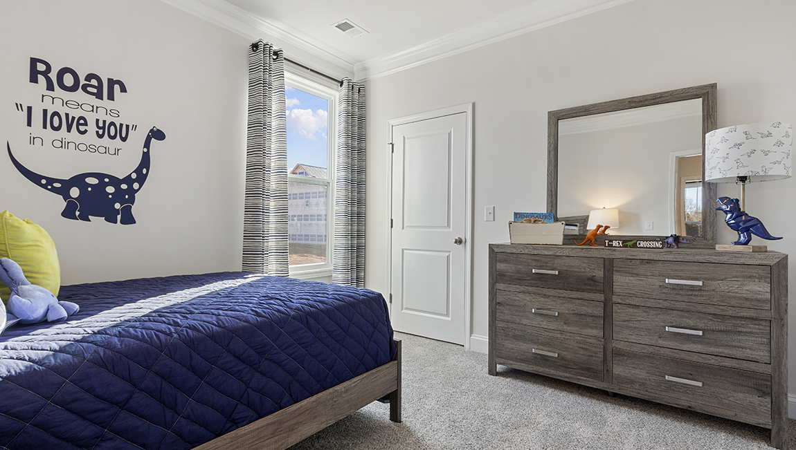 Bedroom with carpet and windows.
