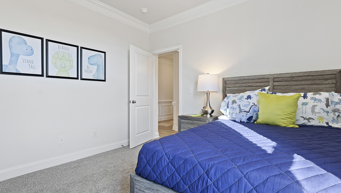 Bedroom with carpet and windows.