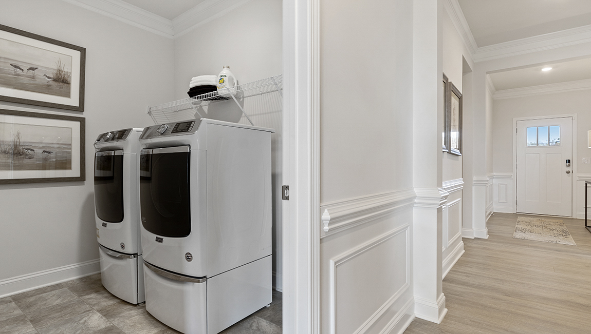 Laundry room with view of hallway.