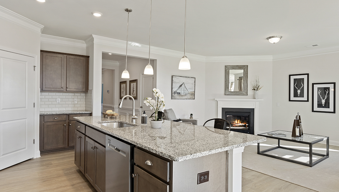 Kitchen and island with view of family room.