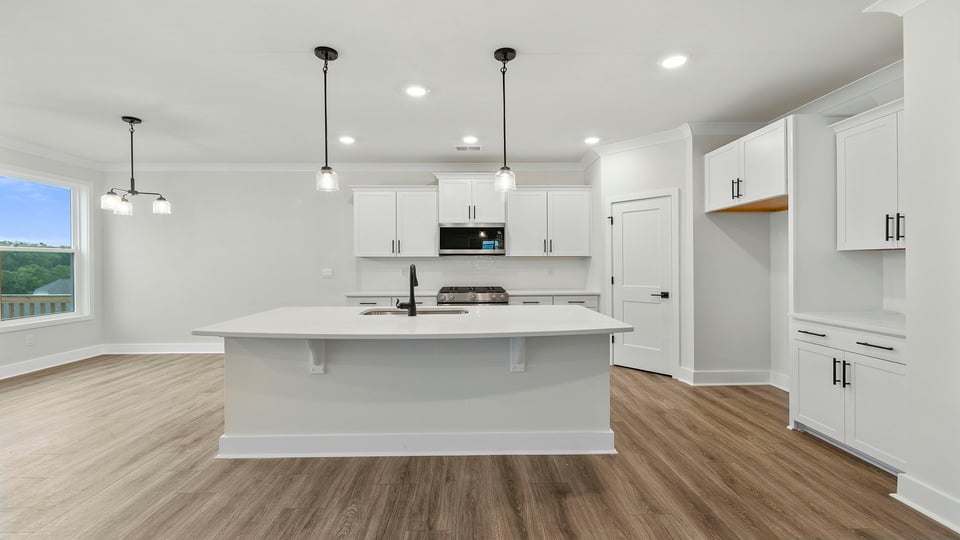 Kitchen with island and cabinets.