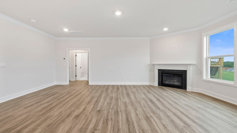 Living area with windows and fireplace.