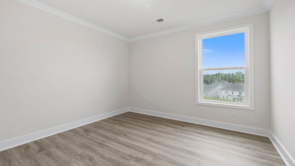 Bedroom with closet and window.