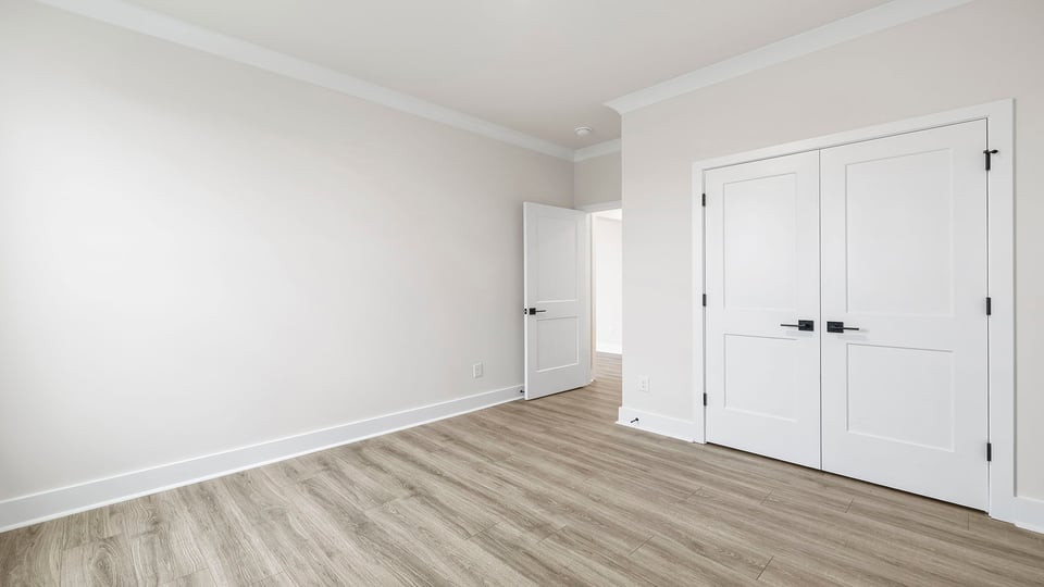 Bedroom with closet and window.