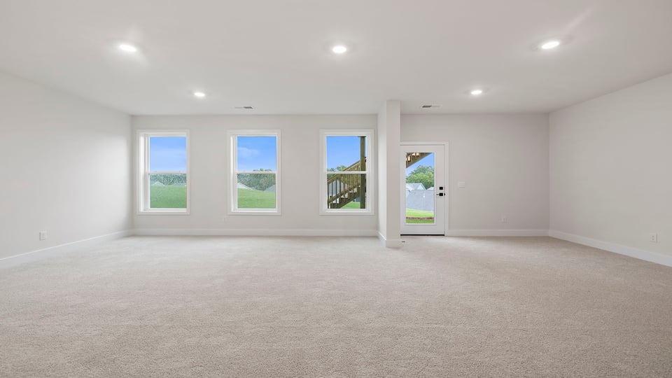 Basement with carpet and windows.