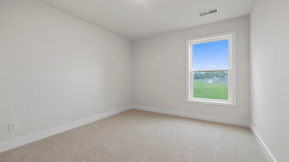 Basement with carpet and windows.