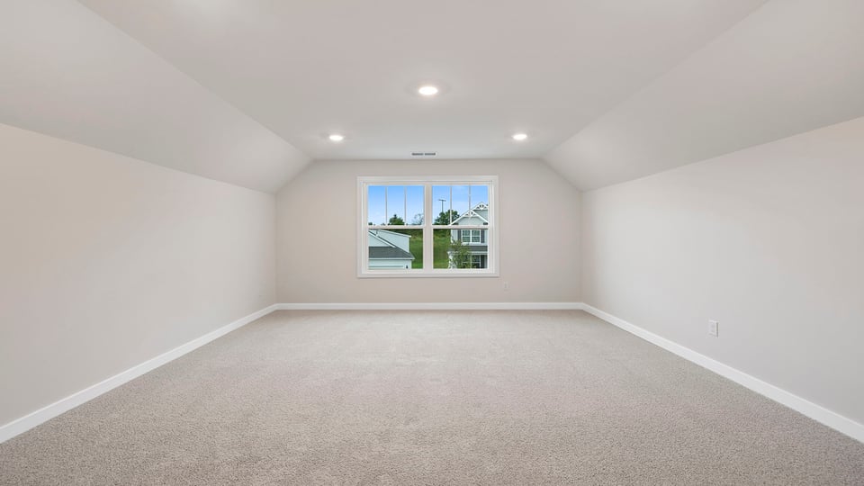 Basement with carpet and windows.