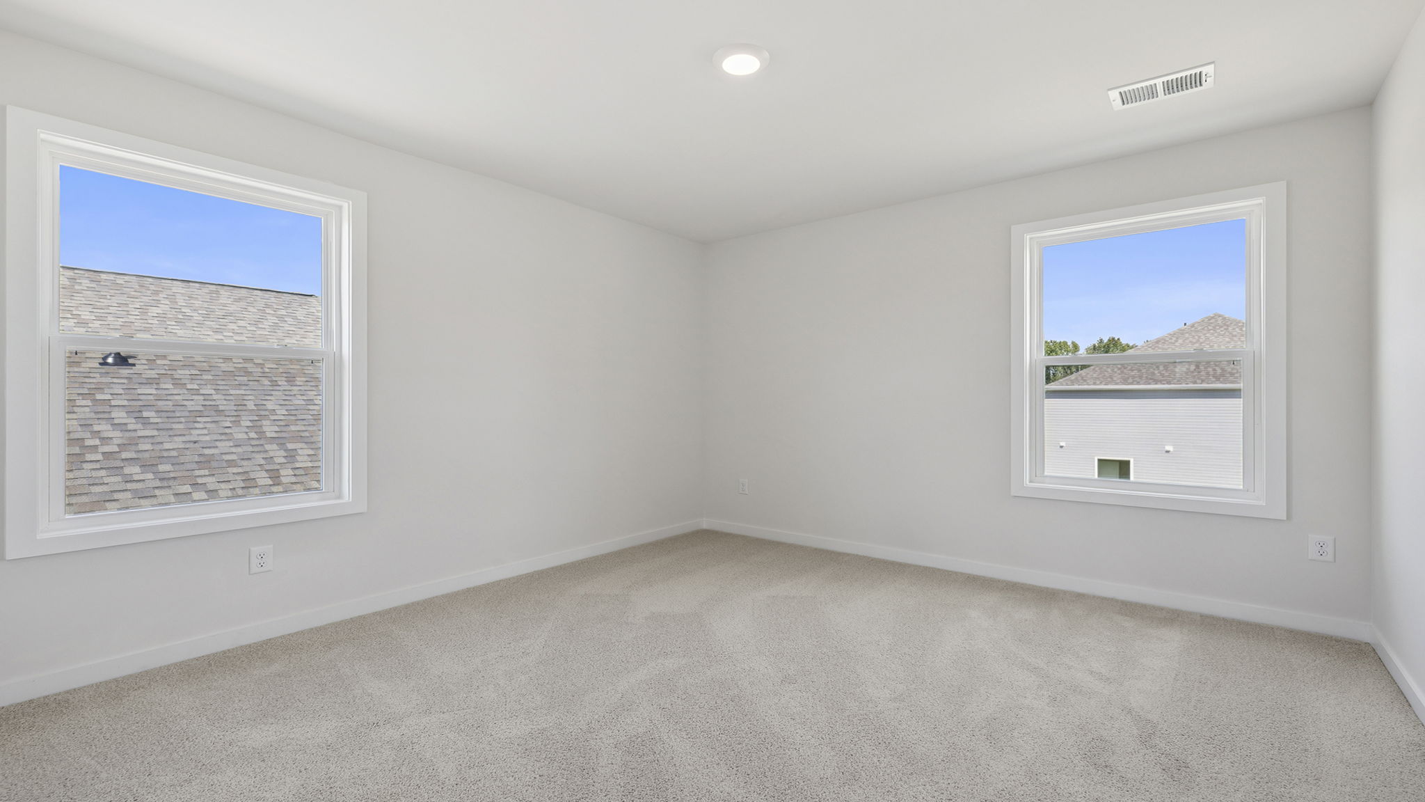 Bedroom with window and carpet.