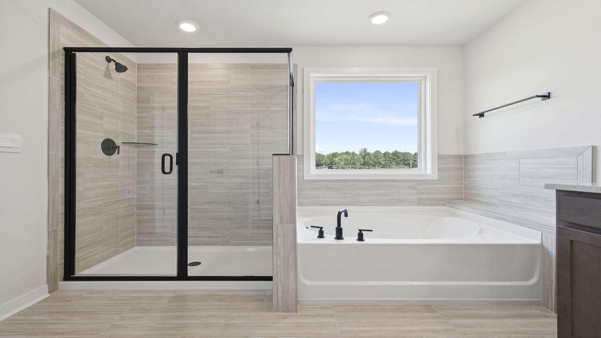 Primary bathroom with walk-in shower and garden tub.