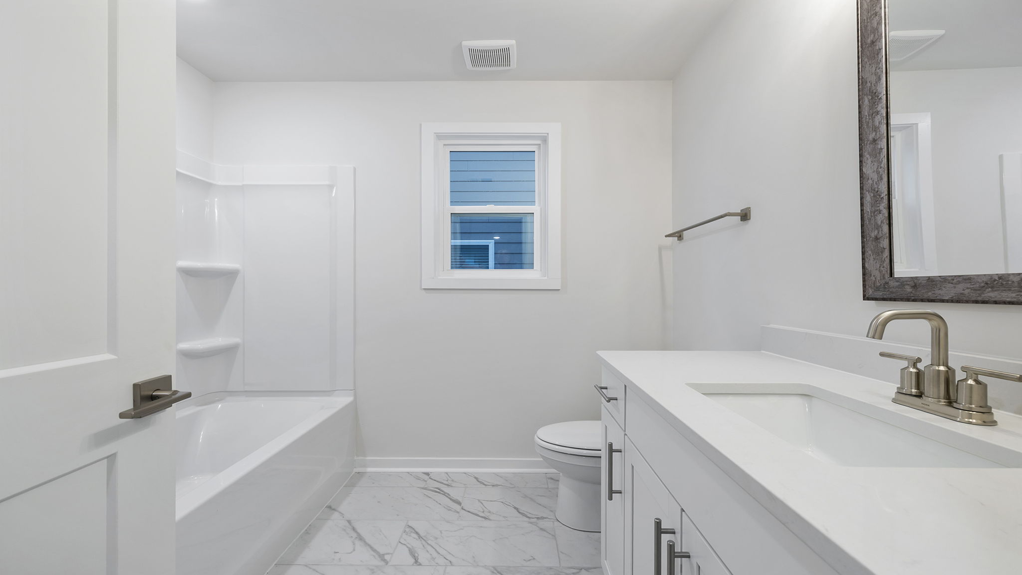 Hall bathroom with vanity and combination shower / tub.