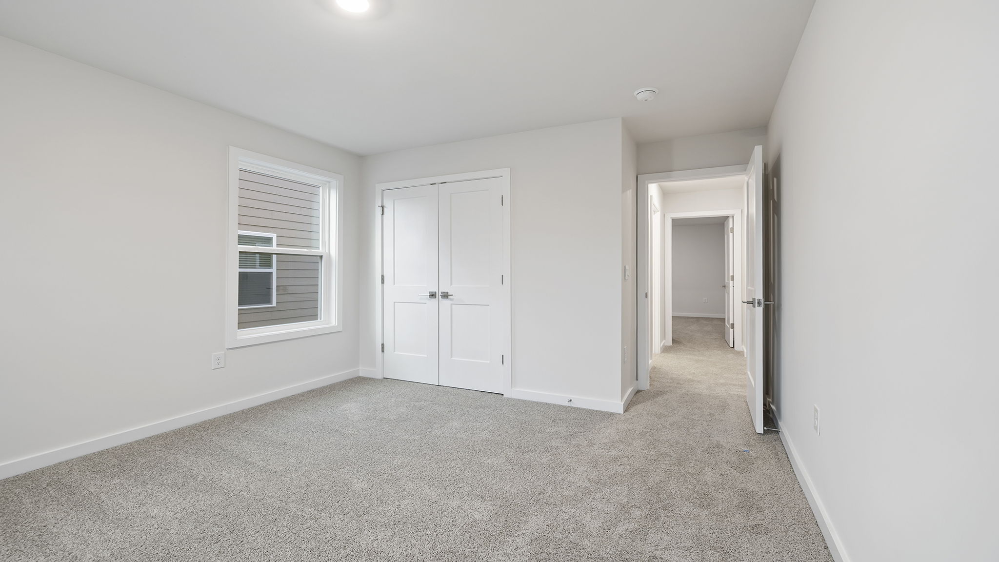 Bedroom with carpet and window.