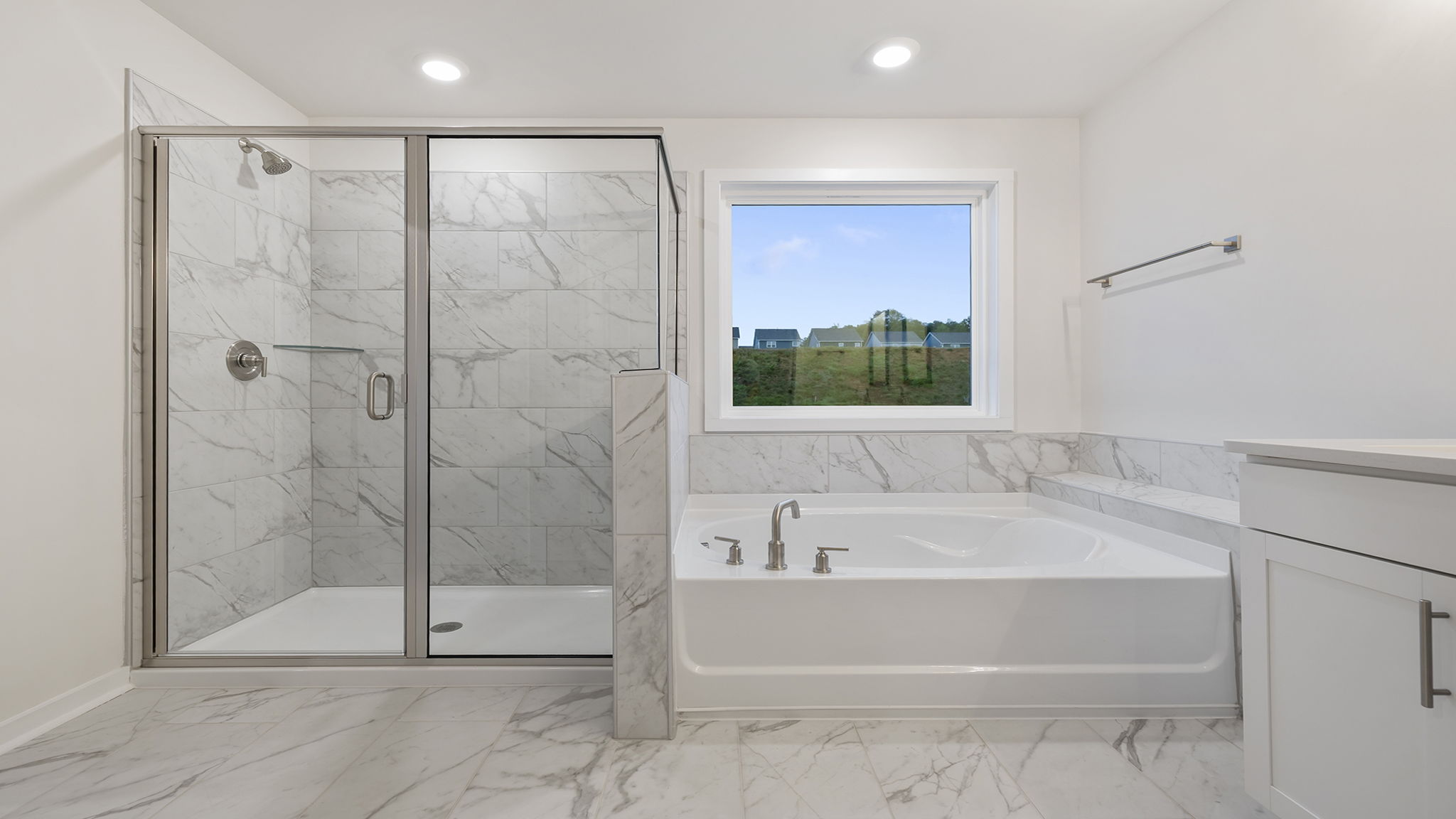 Primary bathroom walk-in shower and garden tub.