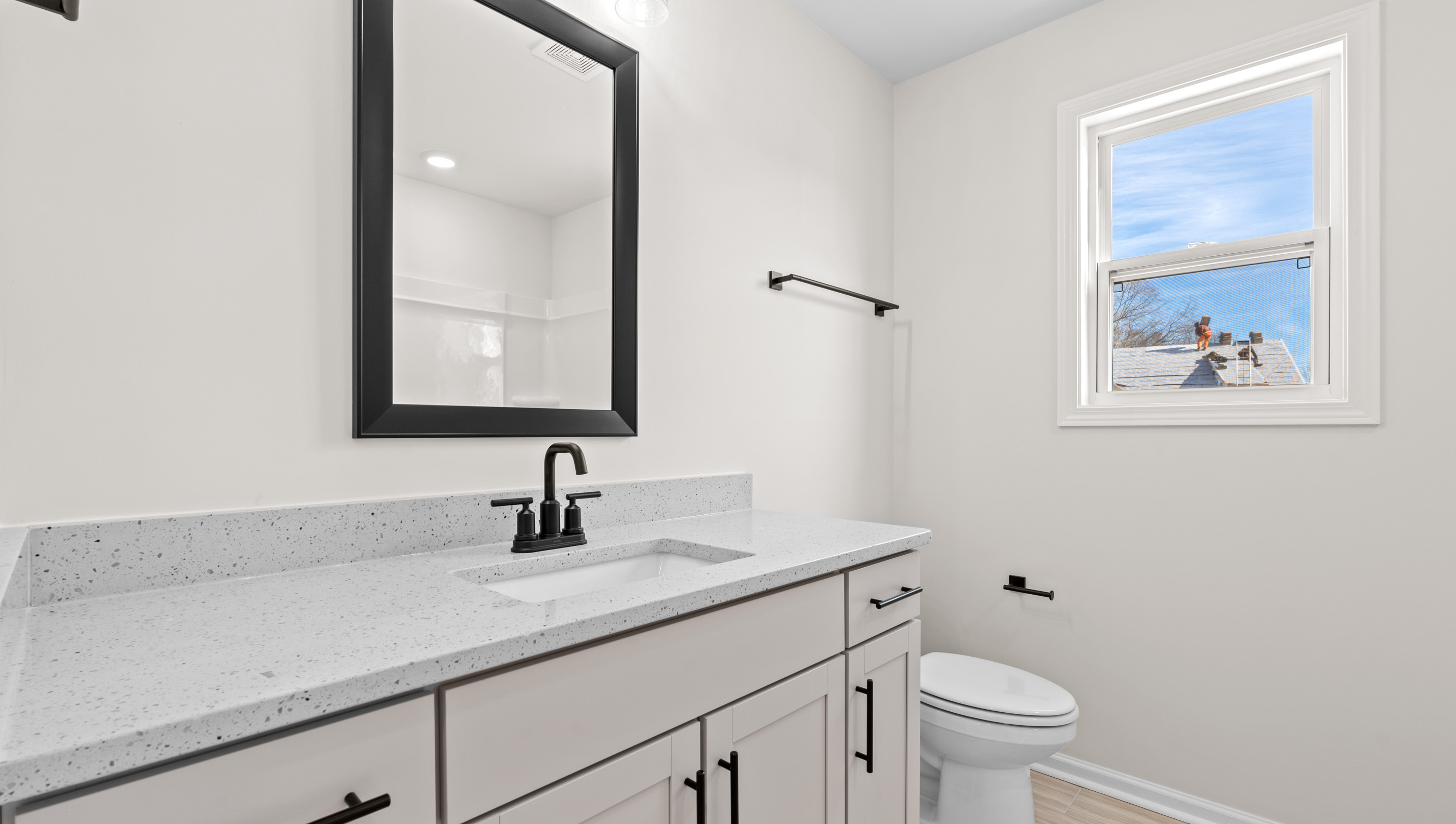 Bathroom with double vanity sink and window.