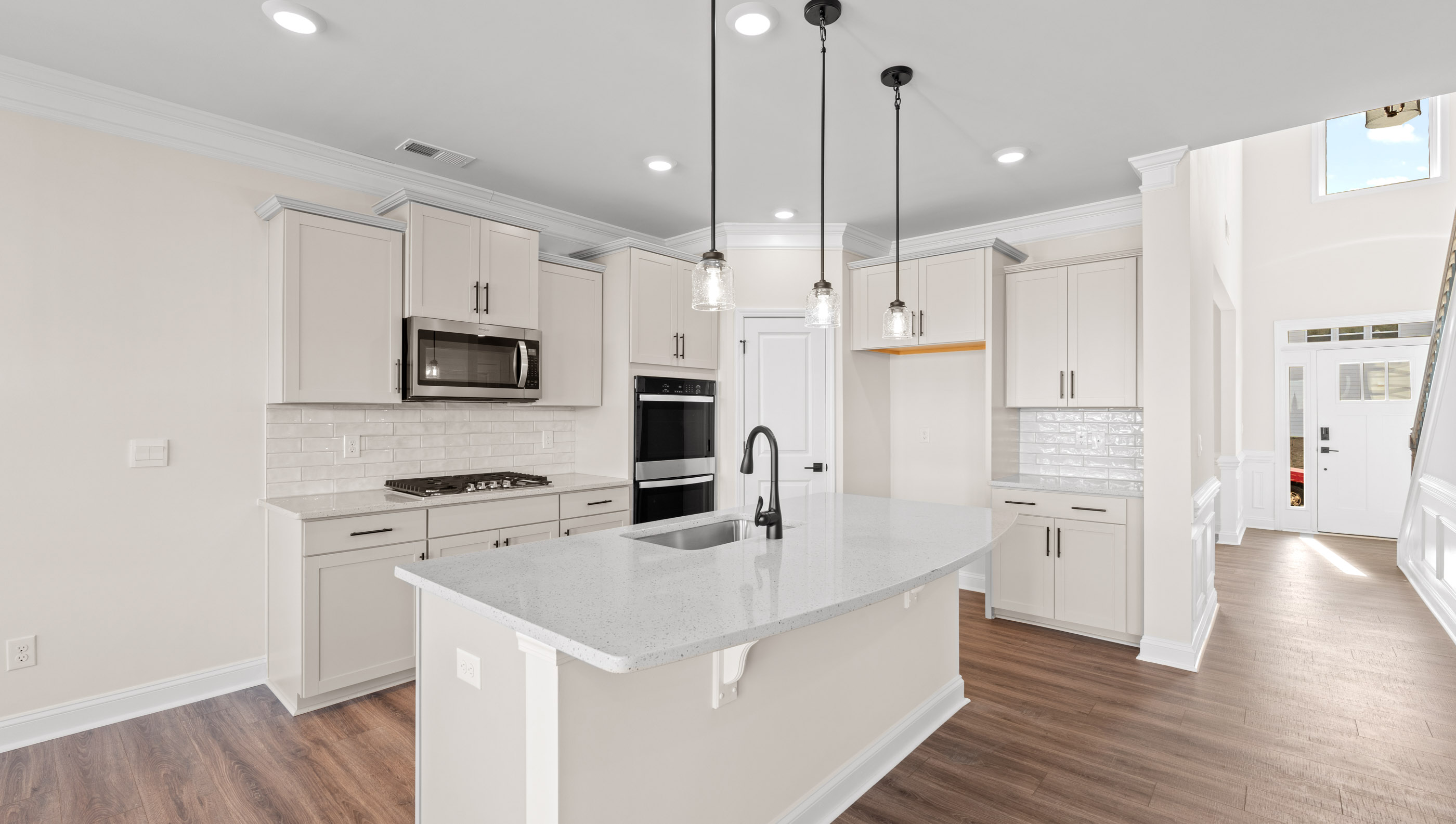 Kitchen and island with granite counter tops.