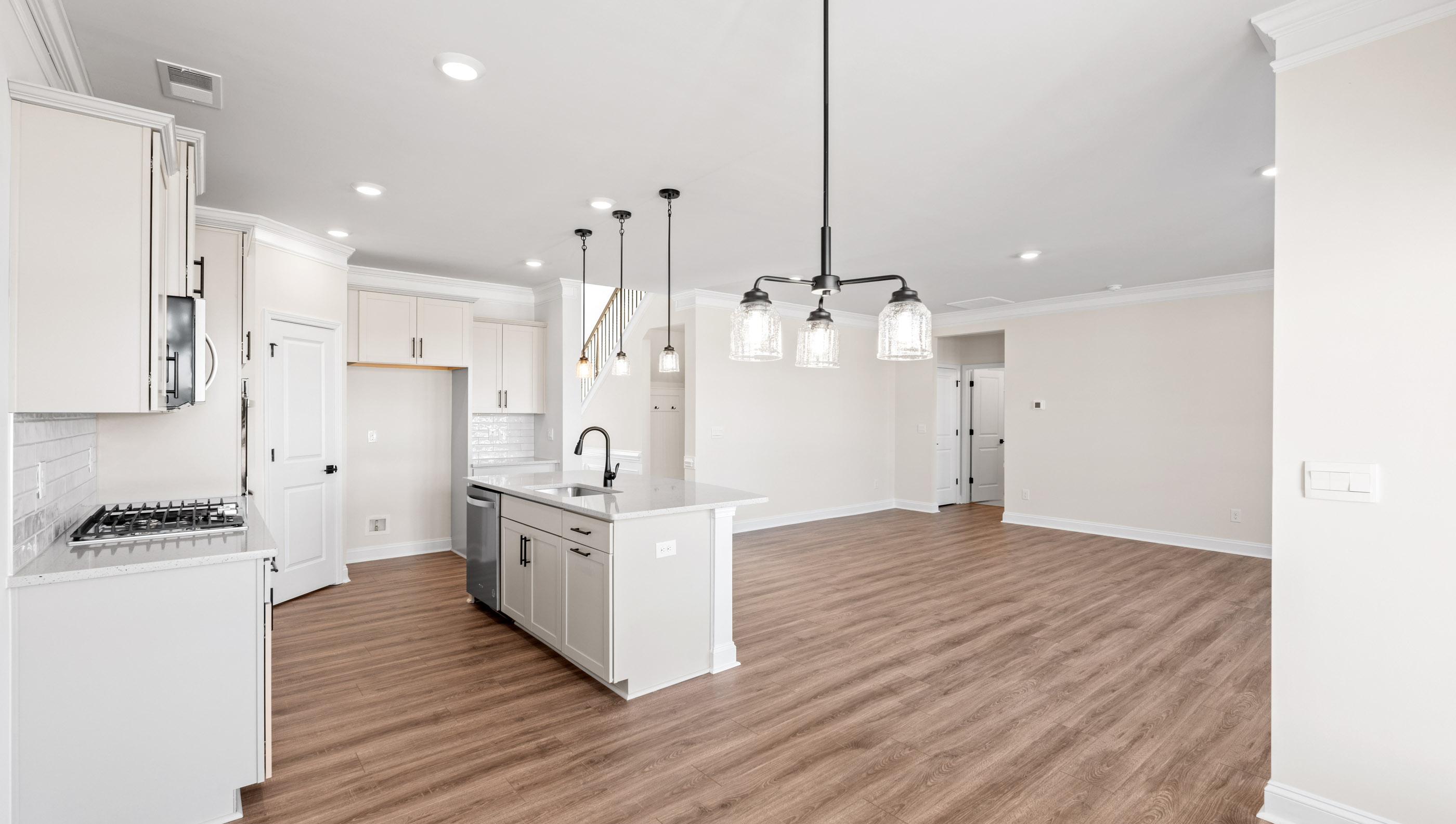 Kitchen with island and white cabinets.
