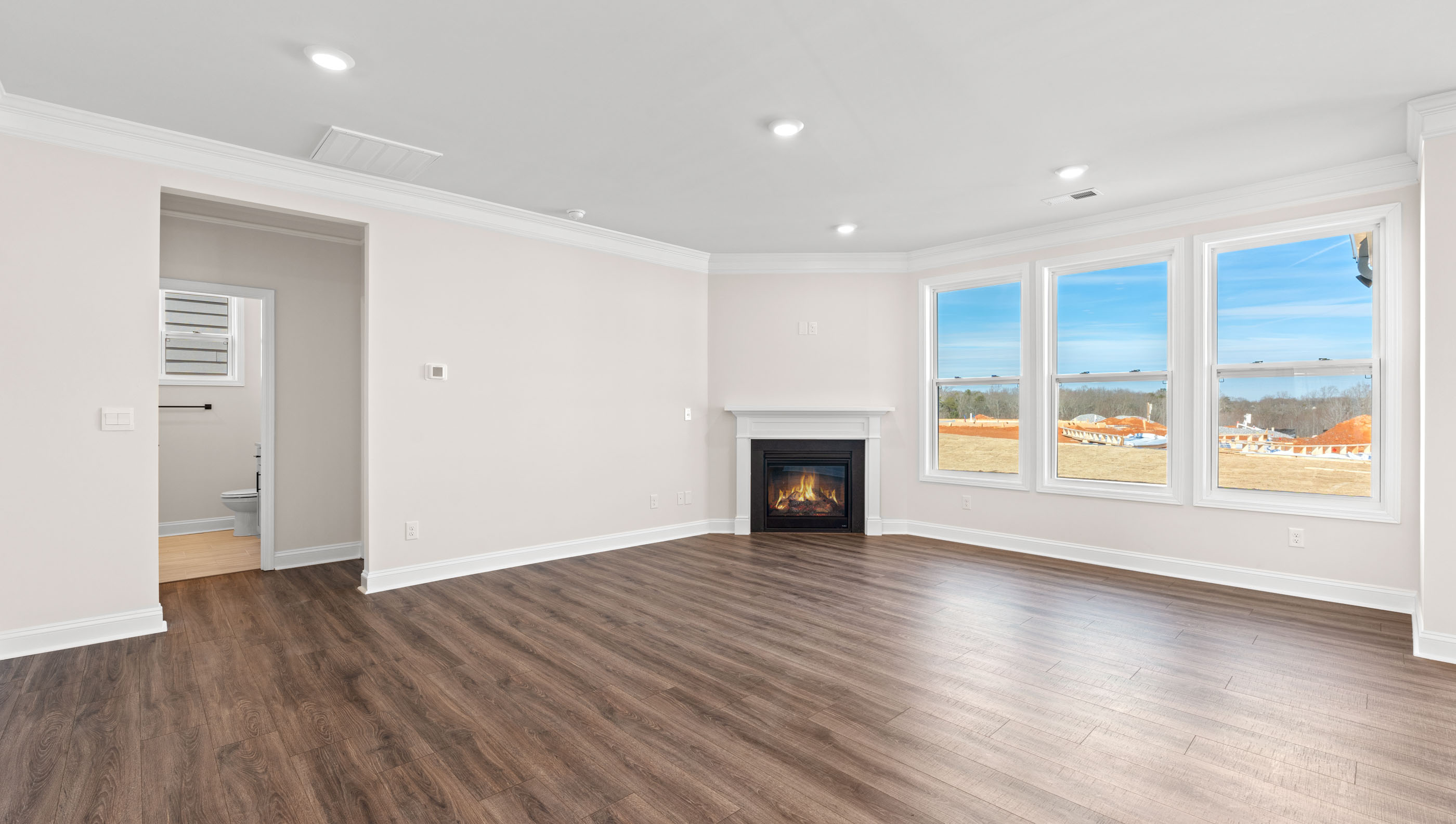 Family room with fireplace and windows.