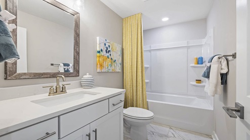 Bathroom with vanity sink and shower.