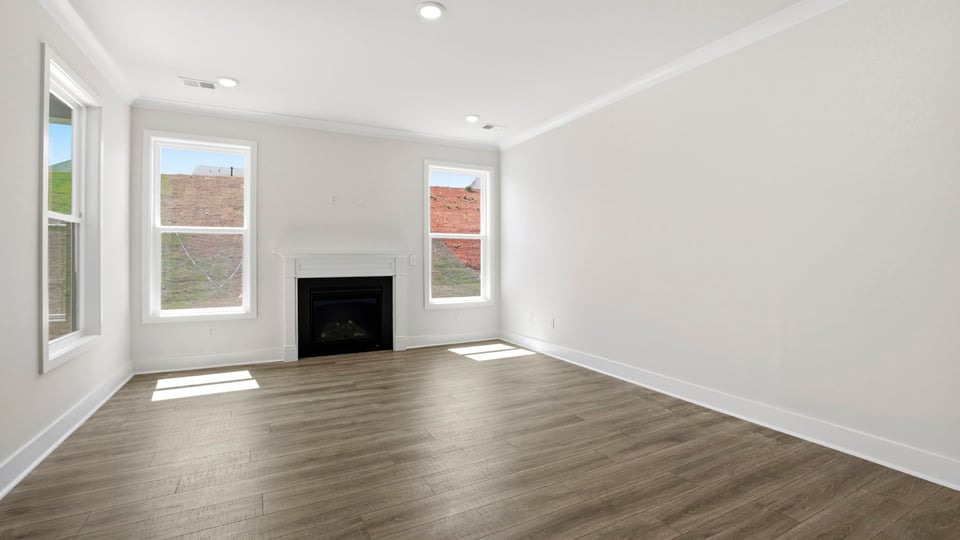 Living area with windows and fireplace.