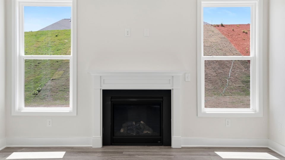 Living area with windows and fireplace.
