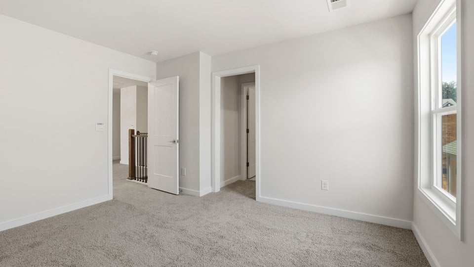Bedroom with carpet and window.