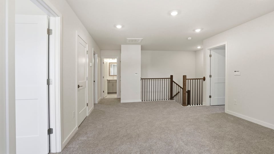 Loft with carpet and windows.