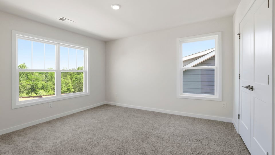 Loft with carpet and windows.