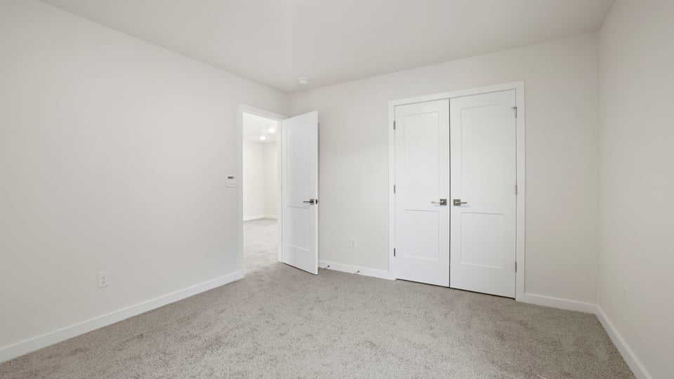 Bedroom with carpet and window.