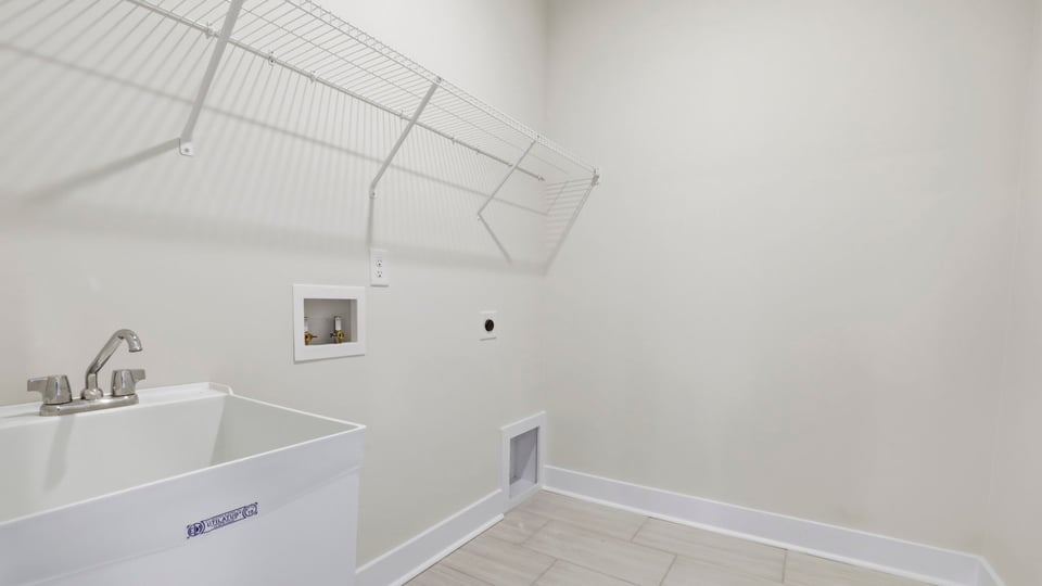 Laundry room with shelf.