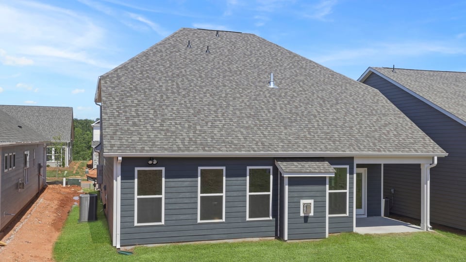 Back exterior with large backyard.