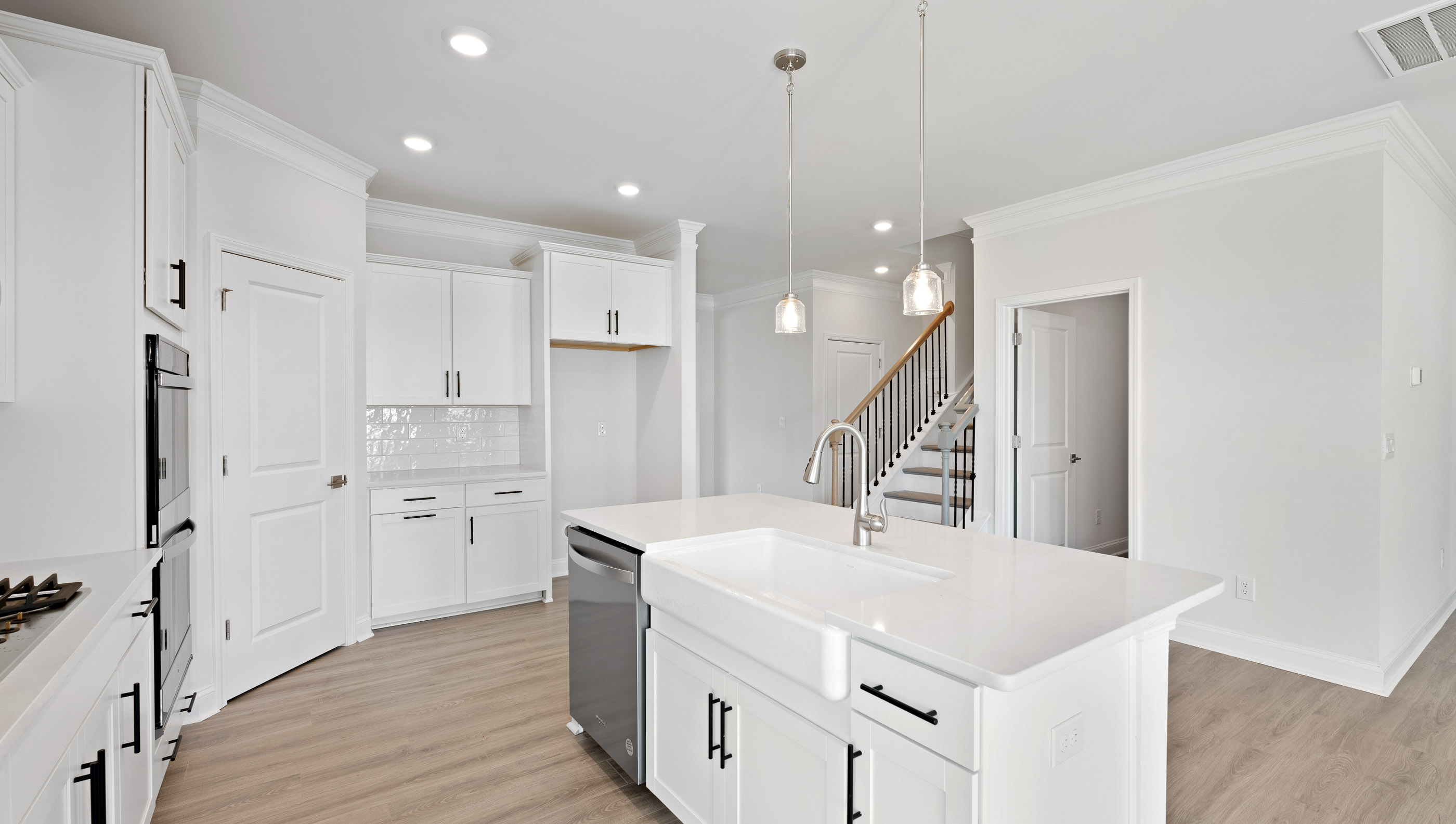 Island and kitchen with quartz countertops.
