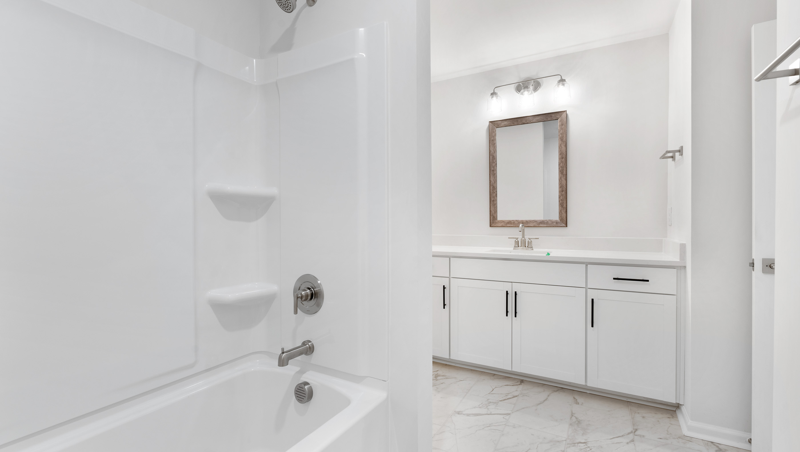 Bedroom with vanity and combination shower / tub.