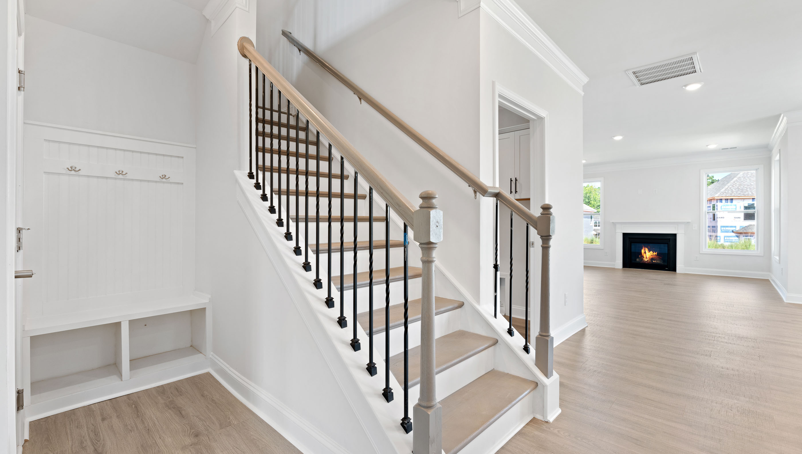 View of hallway toward the living areas and stairwell to the upper level.