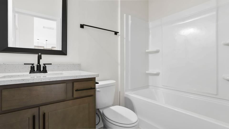 Full bathroom on the main level with vanity and combination shower / tub.