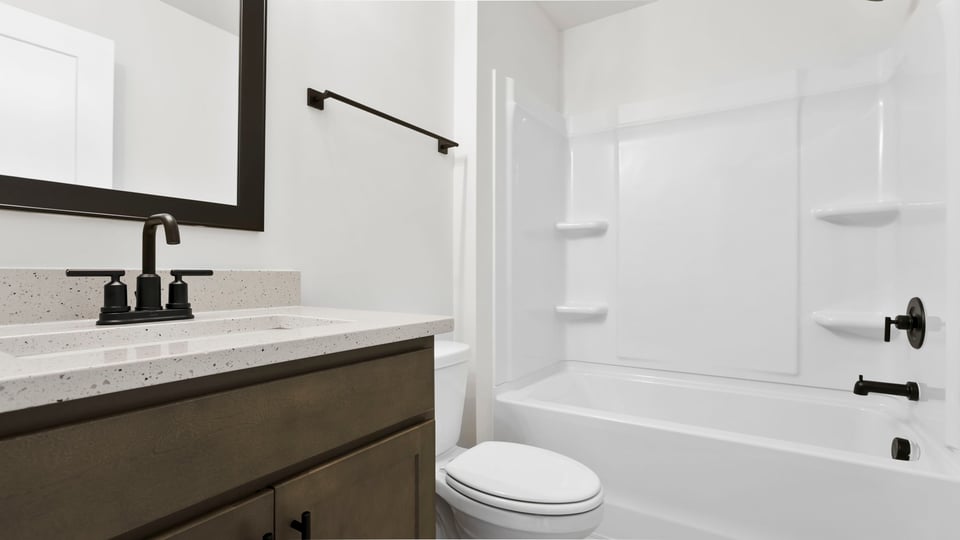 2nd hall bathroom with dual sink vanity and separate shower area.