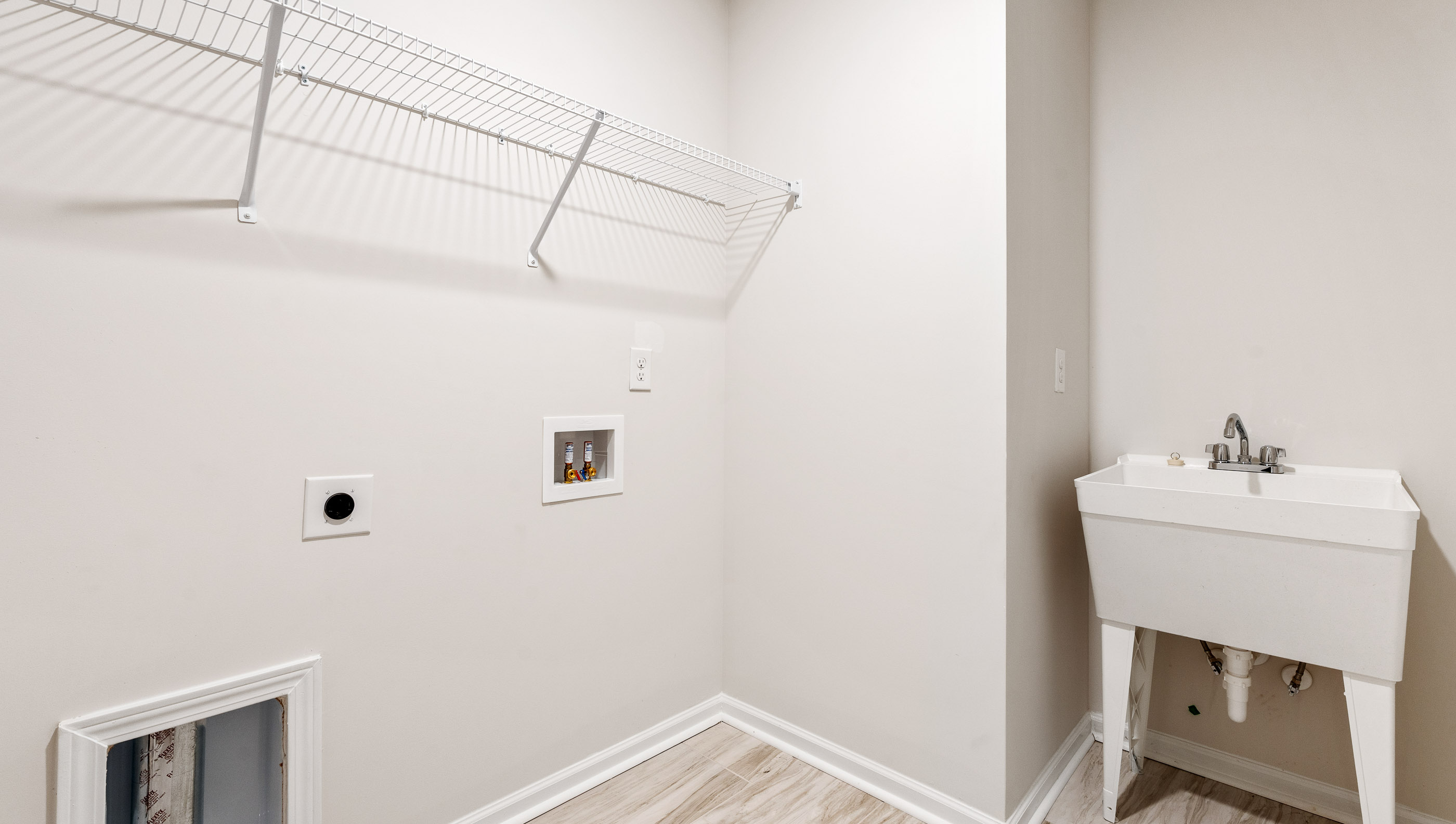 Laundry room with storage racks.