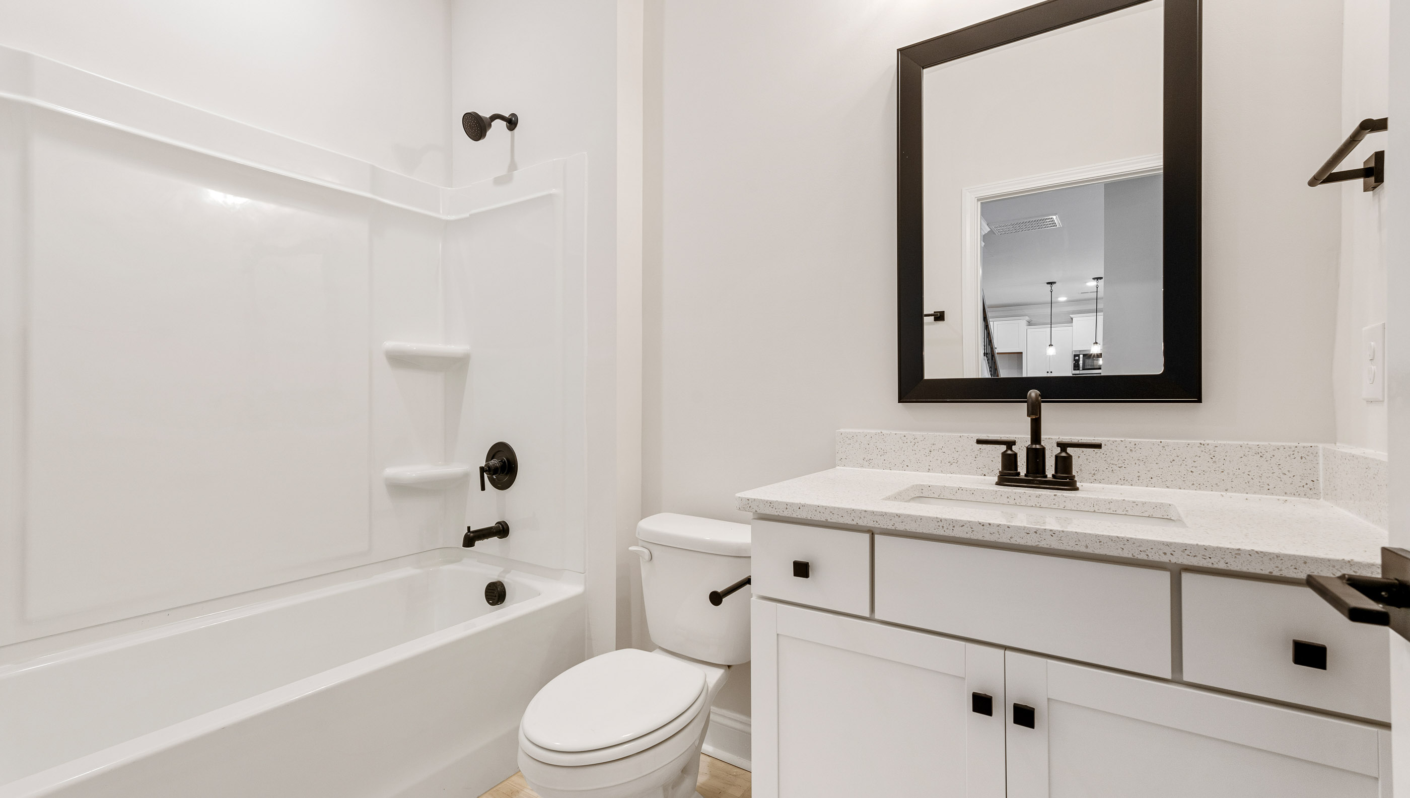 Bathroom with single vanity sink and tub.