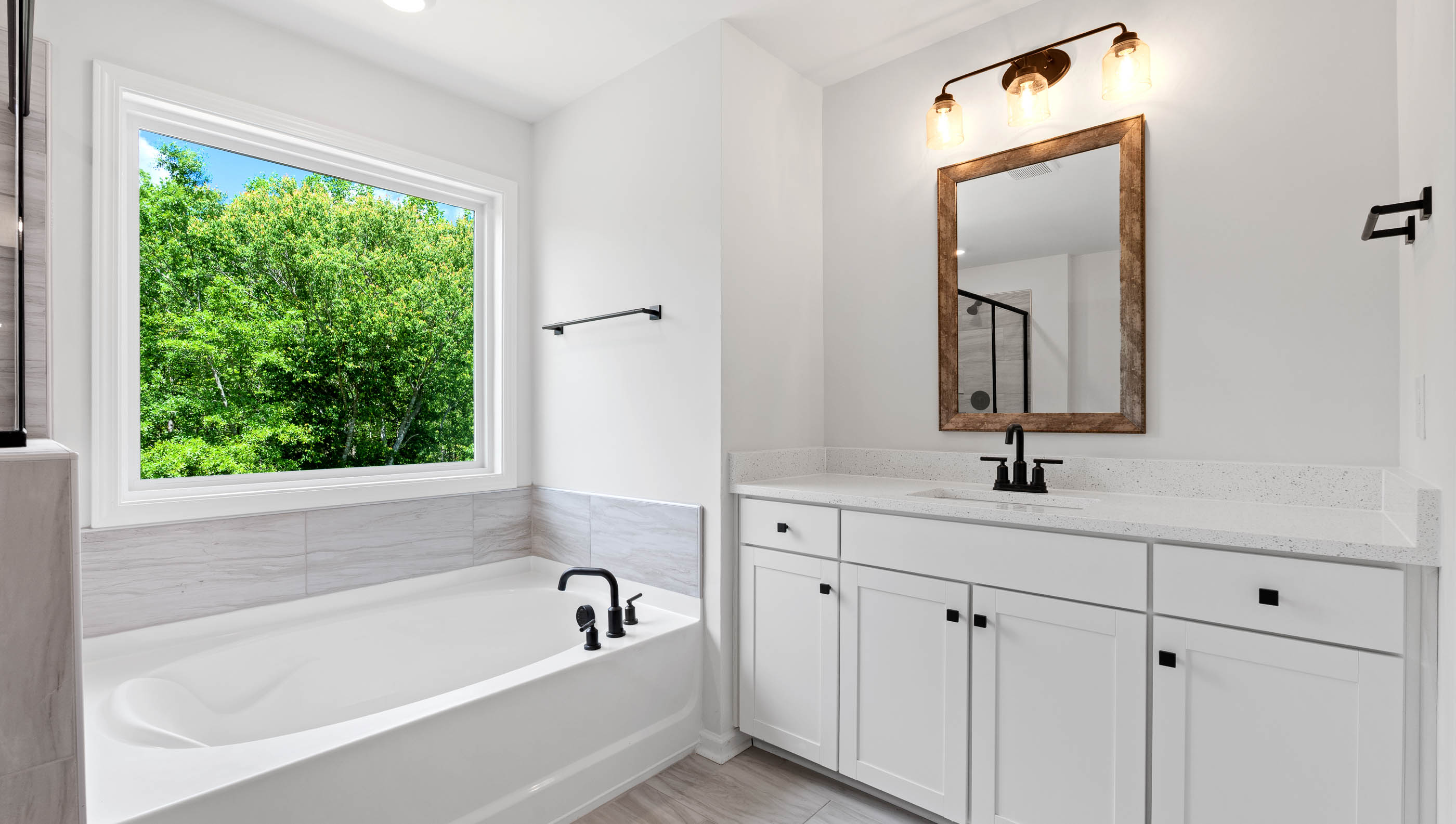 Primary bathroom with dual vanities.