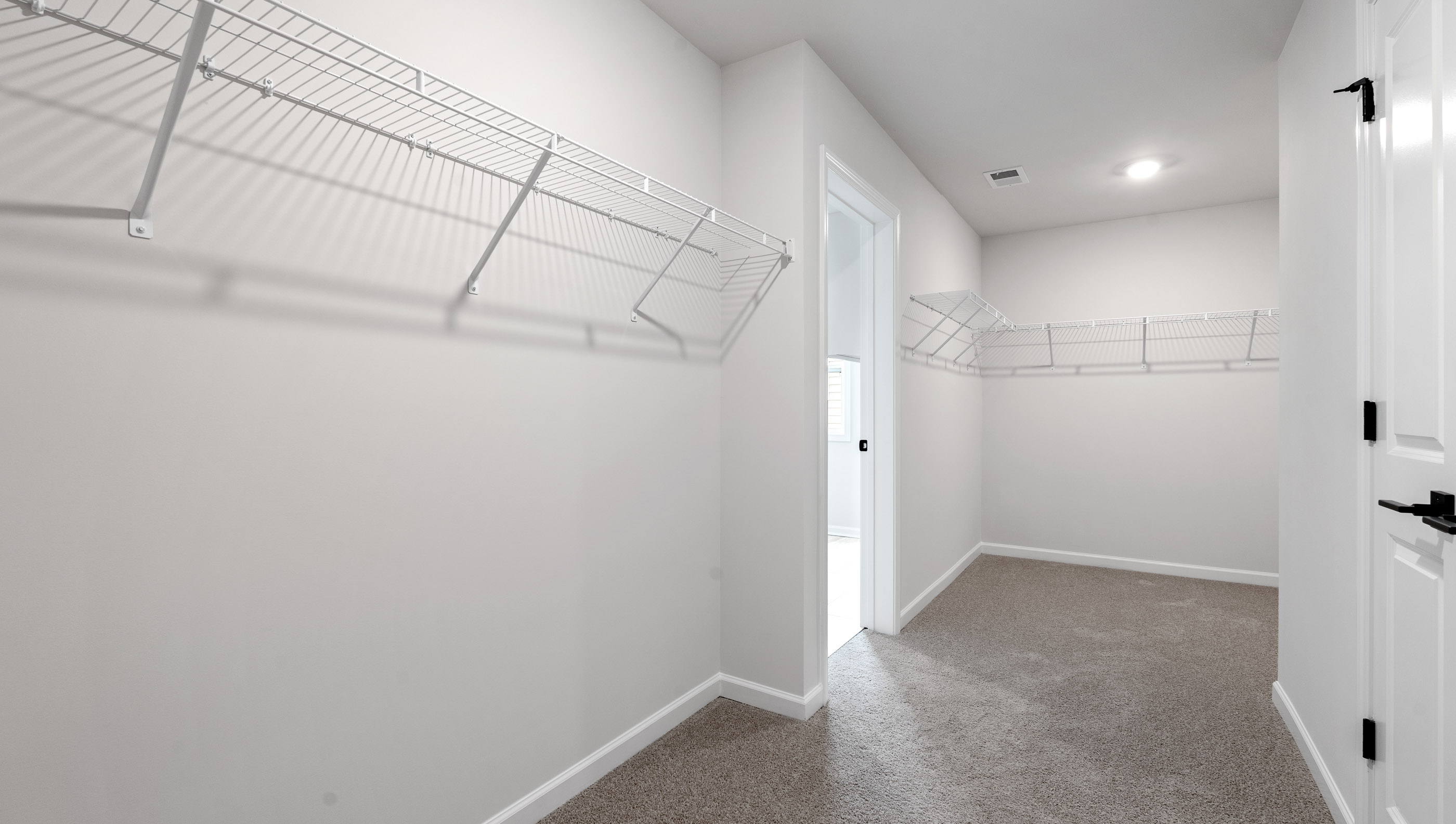 Primary bedroom walk-in closet.