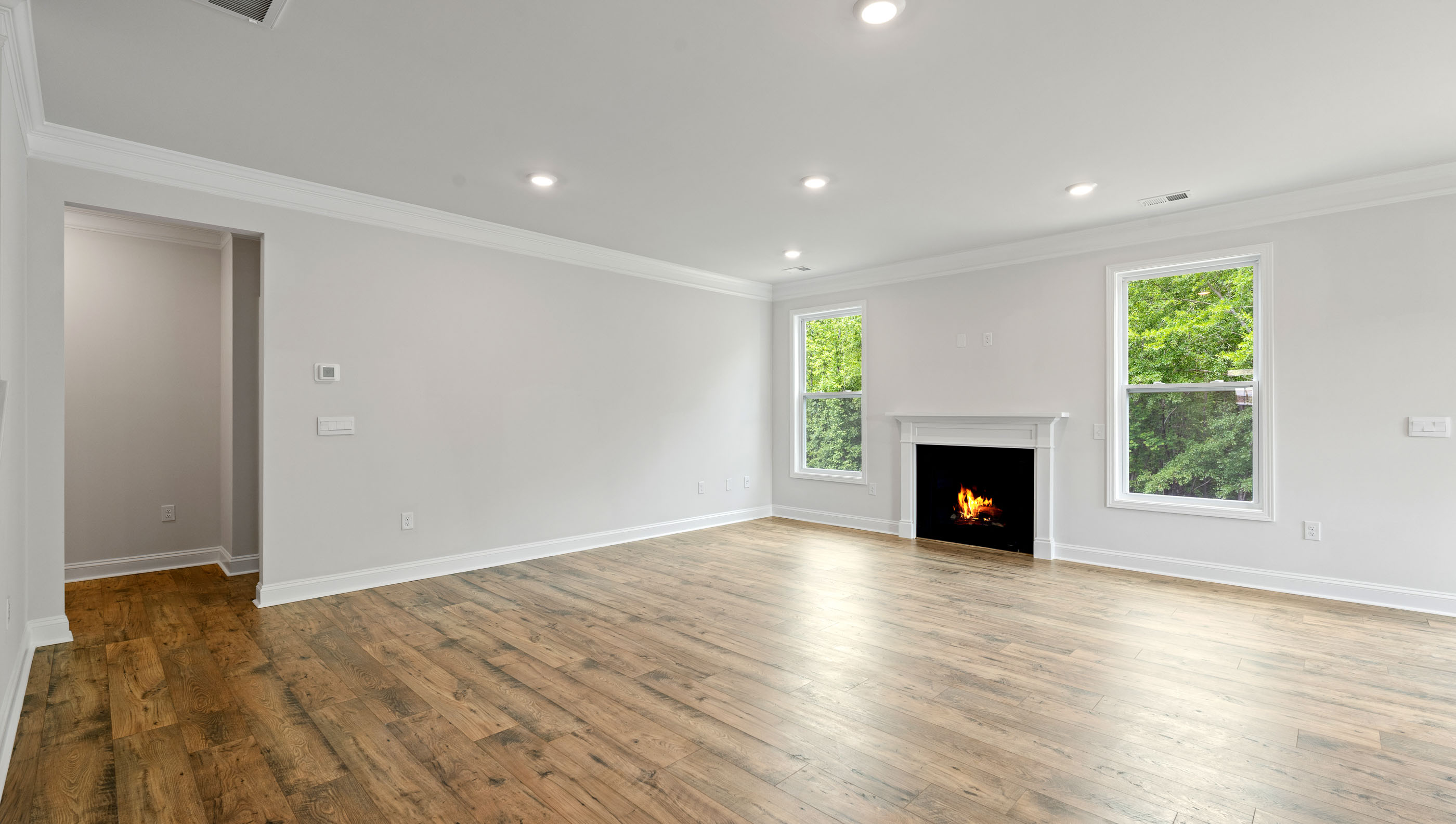 View of large living area with gas log fireplace.