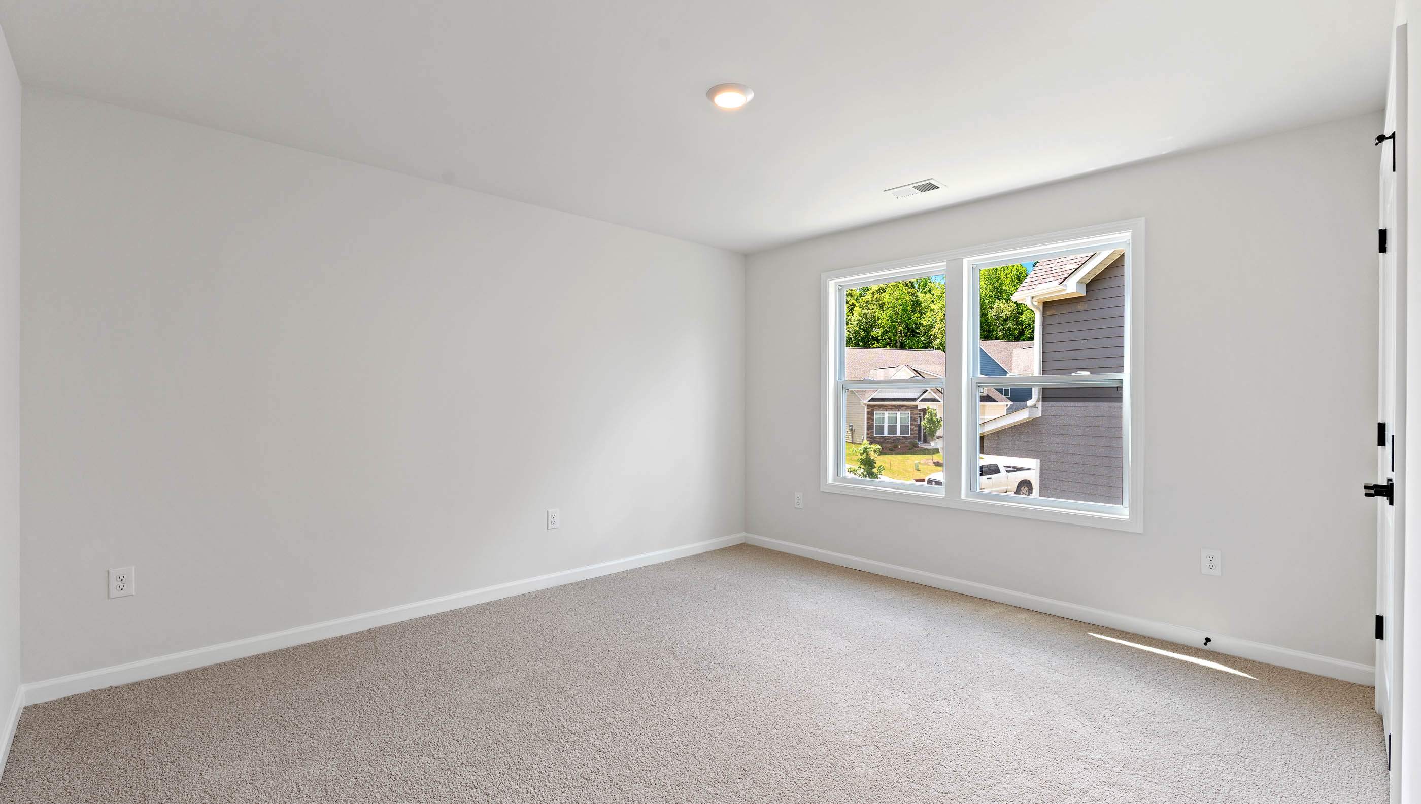Bedroom with carpet and window.