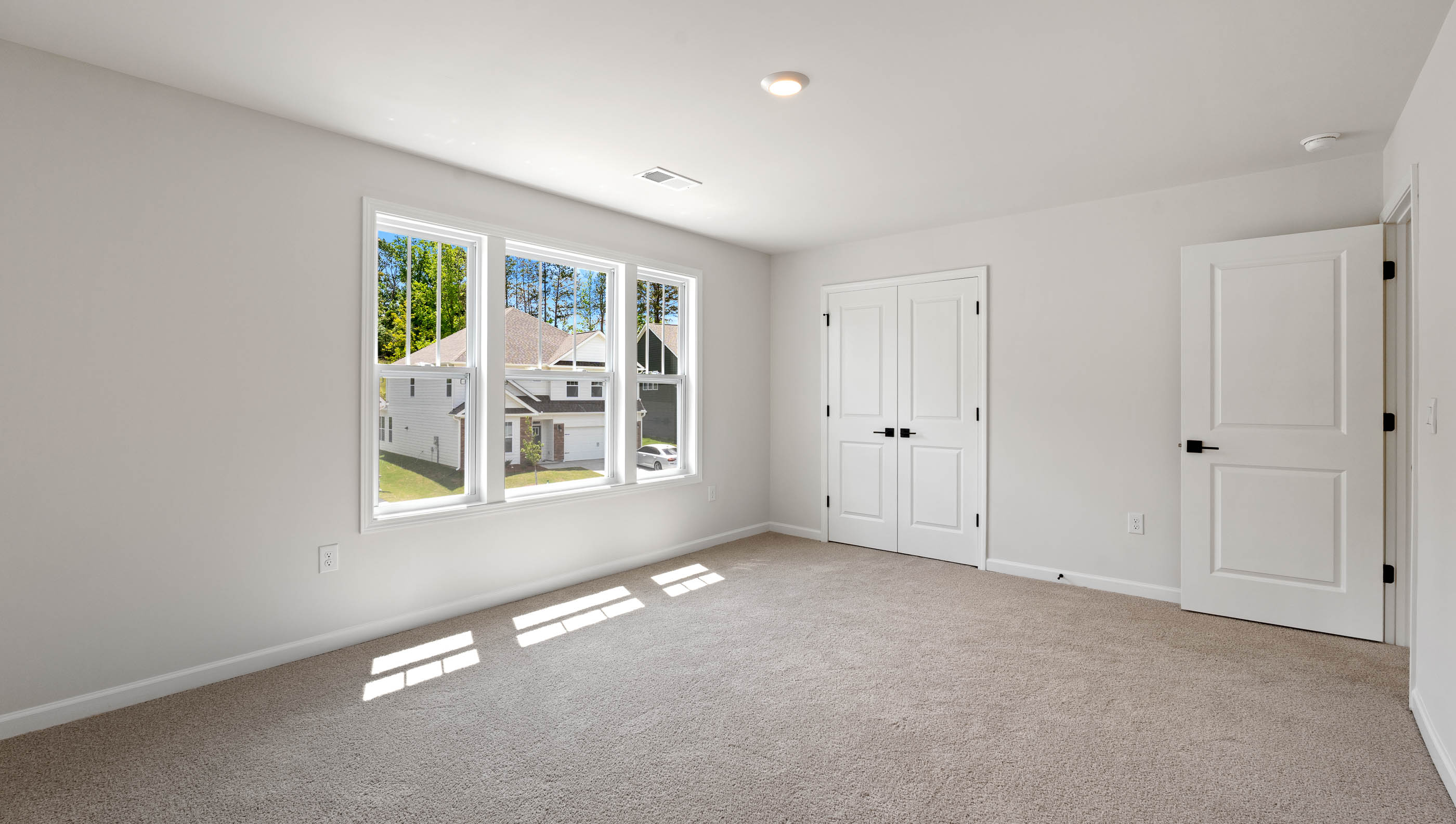 Bedroom with carpet and window.