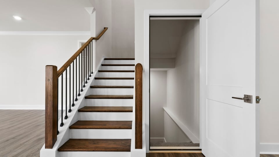 Stairs with banister to second level and basement.
