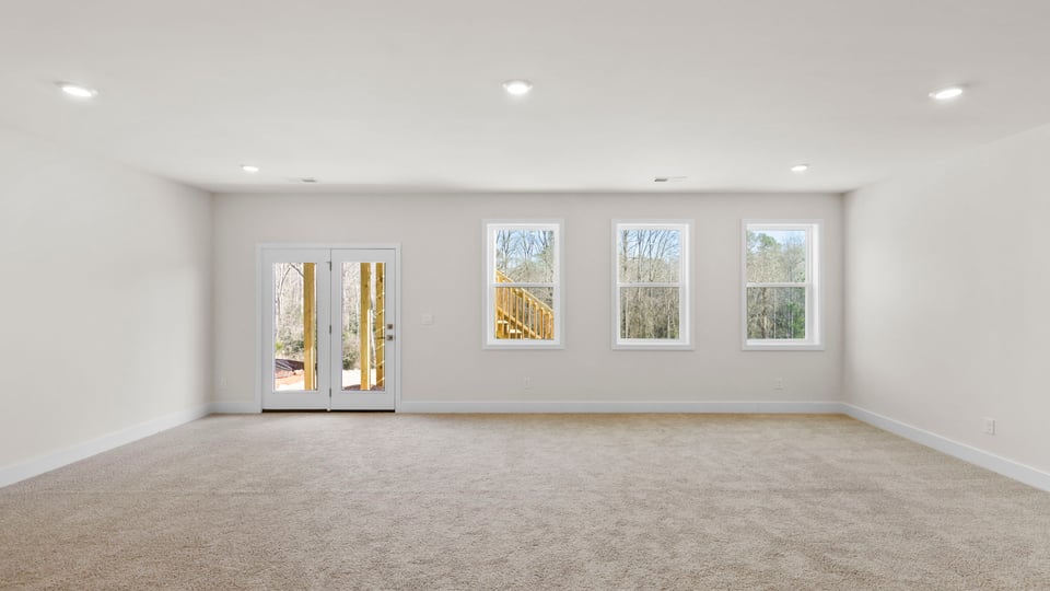 Basement with carpet and windows.