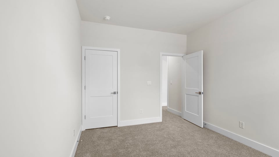 Bedroom with carpet and window.