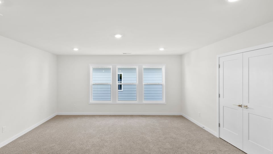 Loft with carpet and windows.