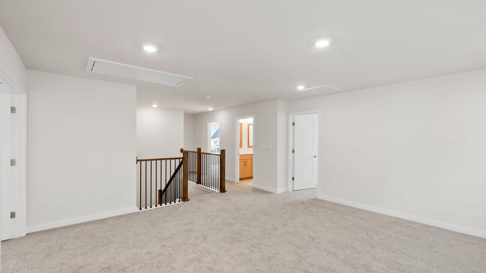 Loft with carpet and windows.