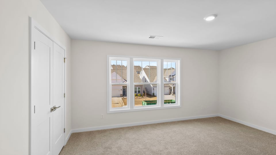 Bedroom with window and closet.