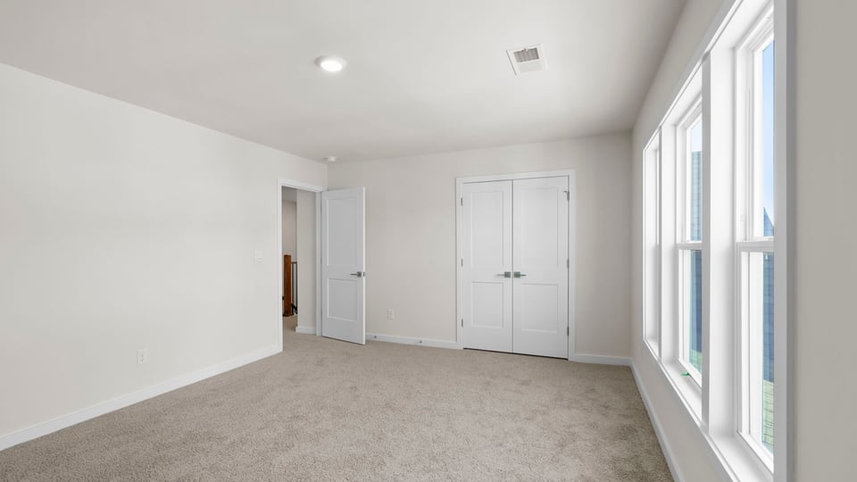 Bedroom with window and closet.